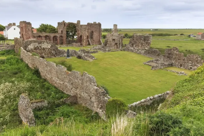 Framed Print : Lindisfarne Priory, early Christian site, and village, elevated view, Holy Island Framed Print : Lindisfarne Priory, early Christian site, and village, elevated view, Holy Island
