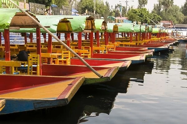 Line of colourful boats at the Floating Gardens in Xochimilco, UNESCO World Heritage Site, Mexico City, Mexico, North America