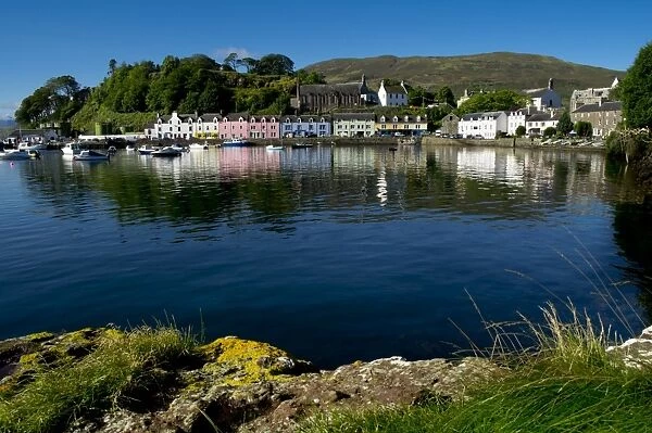 A line of port houses forms the backdrop to the waterfront of Portree Harbour on the Isle of Skye, Inner Hebrides, Scotland, United Kingdom, Europe