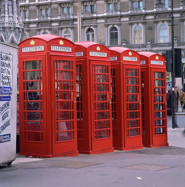 A line of four red telephone boxes at Charing Cross, London, England, United Kingdom