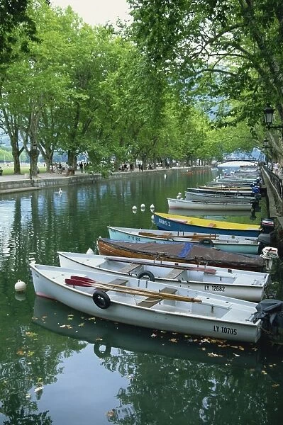 A line of rowing boats along the Canal near the Pont des Amours, in Annecy