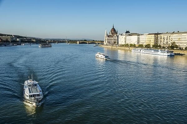 Little ferries on the River Danube in front of the Panorama of Pest, Budapest, Hungary