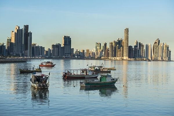 Little fishing boats and the skyline of Panama City, Panama, Central America