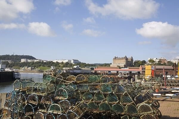 Lobster pots by Old Harbour in South Bay with hotels on South Cliff beyond