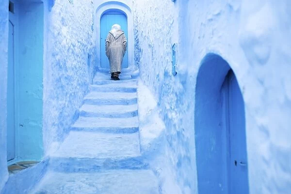 Local man in the blue streets of the Medina, Chefchaouen, Morocco, North Africa, Africa