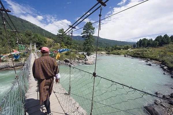 Local man crossing a bridge, Bumthang, Chokor Valley, Bhutan, Asia