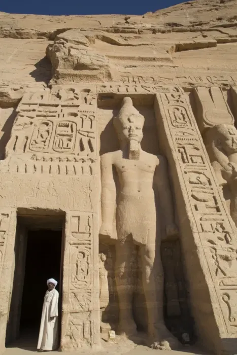Framed Print : Local man at temple entrance, Ramses II statue on right, Hathor Temple of Queen Nefertari Framed Print : Local man at temple entrance, Ramses II statue on right, Hathor Temple of Queen Nefertari