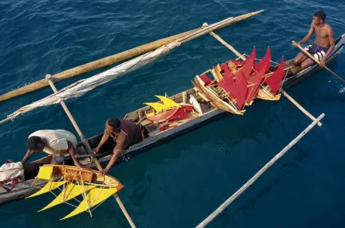 Framed Print : Local men transport model boats by canoe to market Framed Print : Local men transport model boats by canoe to market