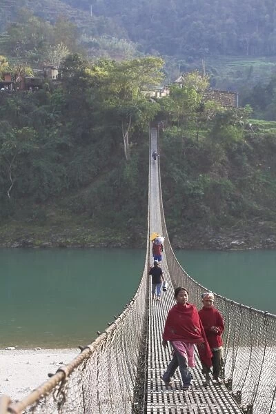 Local people crossing the 160m long suspension bridge