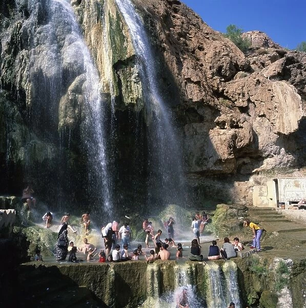 Local people gather at the hot springs and waterfall
