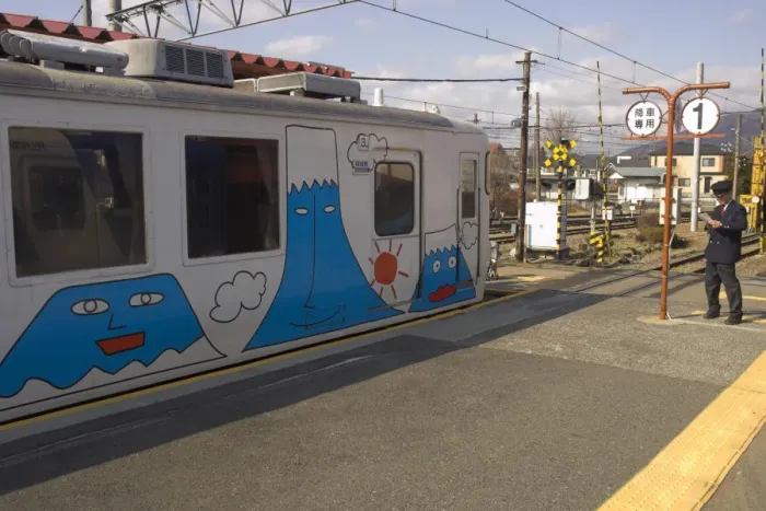 Framed Print : Local train at station platform with fun drawings of Mount Fuji Framed Print : Local train at station platform with fun drawings of Mount Fuji