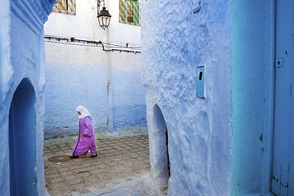 Local women walking through the blue streets of the Medina, Chefchaouen, Morocco