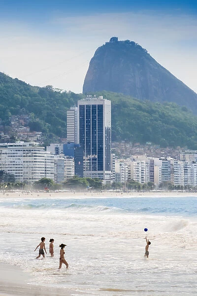 Locals playing ball in the surf, Copacabana Beach, Rio de Janeiro, Brazil, South America