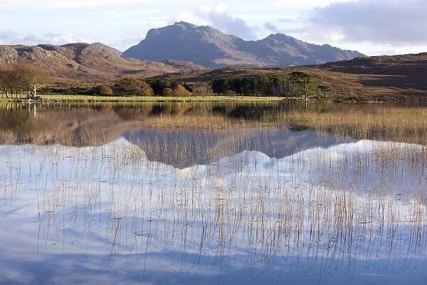 Loch Nan Dailthean with reflections and Beinn Airigh Charr rising in background