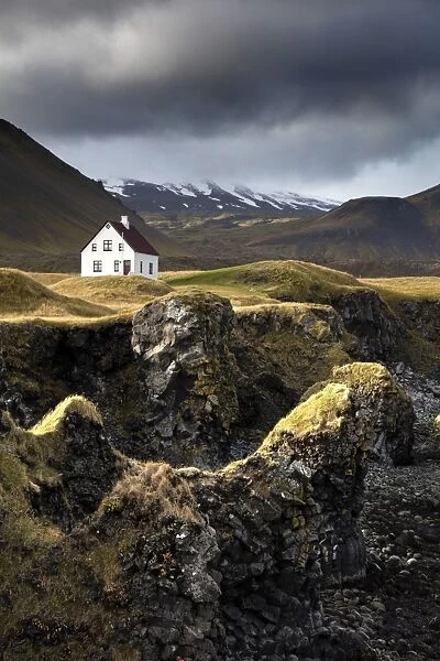 Lone house and sea stacks in stormy weather, Arnastapi, Snaefellsnes Peninsula, Iceland