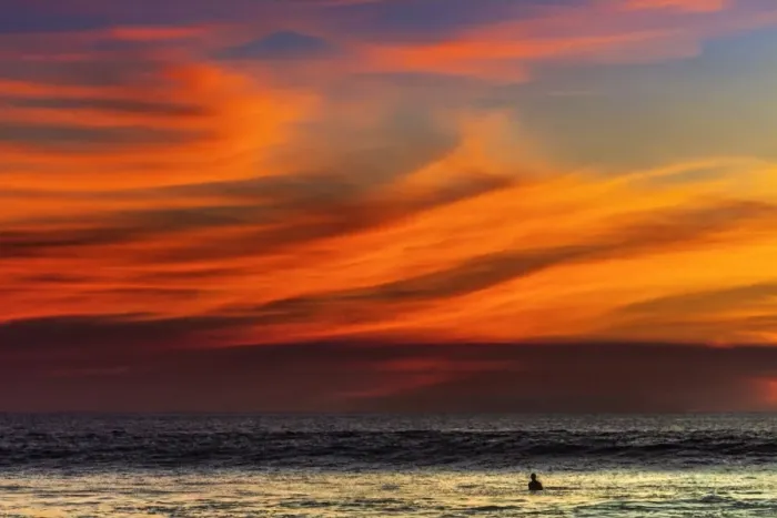 Framed Print : Lone surfer and sunset clouds off Playa Hermosa surf beach, southern Nicoya Peninsula