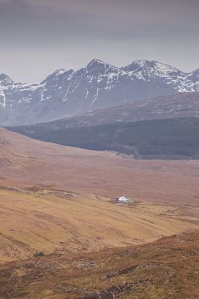 A lonely house sits in the shadow of the Cuillins on the Isle of Skye, Inner Hebrides, Scotland, United Kingdom, Europe