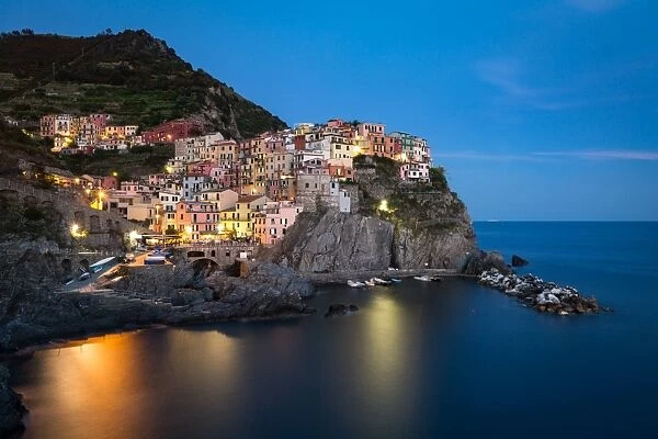A long exposure at blue hour as the lights come on in the colourful town of Manarola