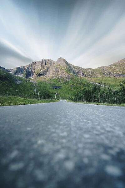 Long exposure of clouds over mountains view from the empty road, Senja, Troms county