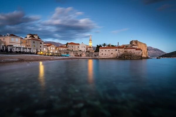 A long exposure during the evening blue hour of the beach and stari grad (old town) of Budva