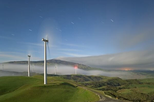 A long exposure by moonlight of windmills in Te Apiti Wind Farm