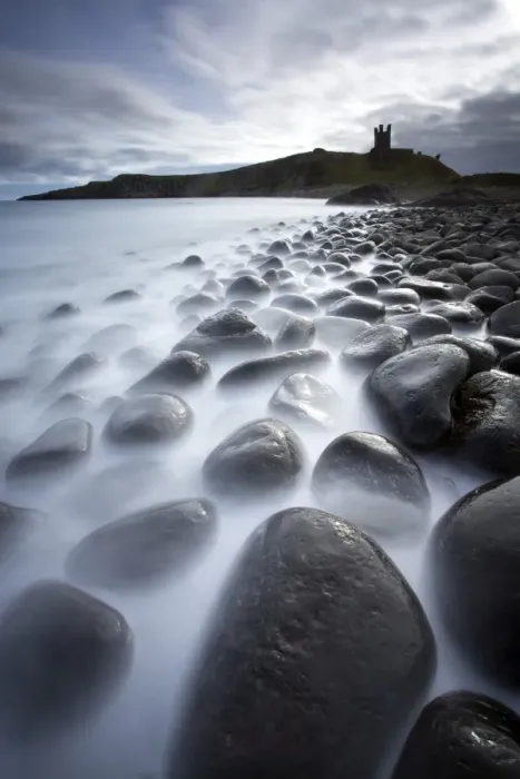 Framed Print : Long exposure to record motion in the sea as it washes around black basalt boulders on a beach at Embleton Bay with the silhouette of Dunstanburgh Castle in the distance, Embleton Bay, near Alnwick, Northumberland, England, United Kingdom, Europe Framed Print : Long exposure to record motion in the sea as it washes around black basalt boulders on a beach at Embleton Bay with the silhouette of Dunstanburgh Castle in the distance, Embleton Bay, near Alnwick, Northumberland, England, United Kingdom, Europe