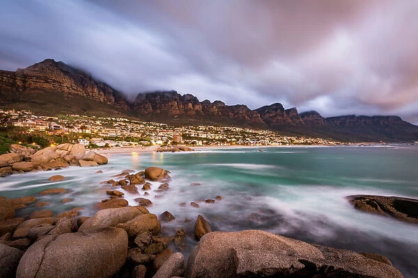 Long exposure at sunset at Camps Bay with cloud over Table Mountain and the Twelve Apostles