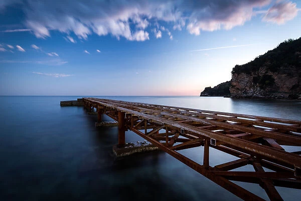 A long exposure during sunset of an old jetty on the beach of Budvas old town (stari grad)