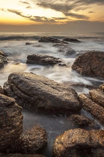 Long exposure of surf and rocks at sunrise, Tangalle, Sri Lanka, Indian Ocean, Asia