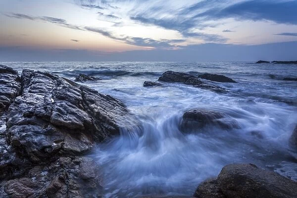 Long exposure of surf and rocks at sunrise, Tangalle, Sri Lanka, Indian Ocean, Asia