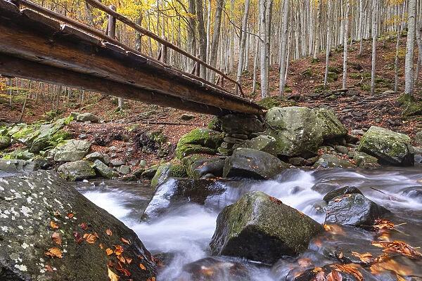 Long exposure waterfalls and a wooden bridge in autumn, Parco Regionale del Corno alle
