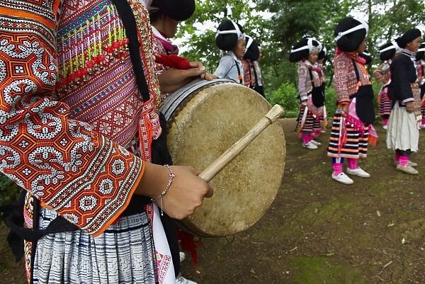 Long Horn Miao girls in traditional costumes celebrating Flower Dance Festival, Longjia village, Guizhou Province, China, Asia
