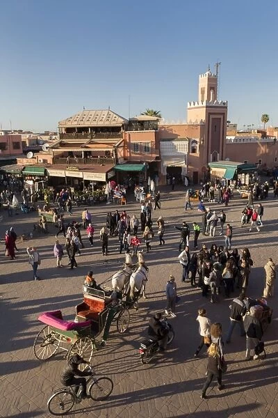 Long shadows in the busy square of Place Jemaa el-Fna, UNESCO World Heritage Site, Marrakech, Morocco, North Africa, Africa
