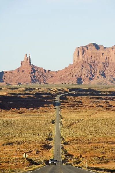 A long straight road leads into Monument Valley Navajo Tribal Park