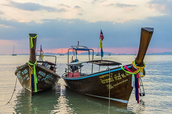 Long tail boats at sunset on Railay beach in Railay, Ao Nang, Krabi Province, Thailand