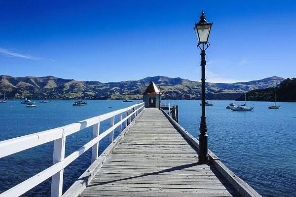 Long wooden pier in Akaroa, Banks Peninsula, Canterbury, South Island, New Zealand, Pacific