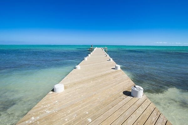 Long wooden pier in the turquoise waters of Providenciales, Turks and Caicos, Caribbean