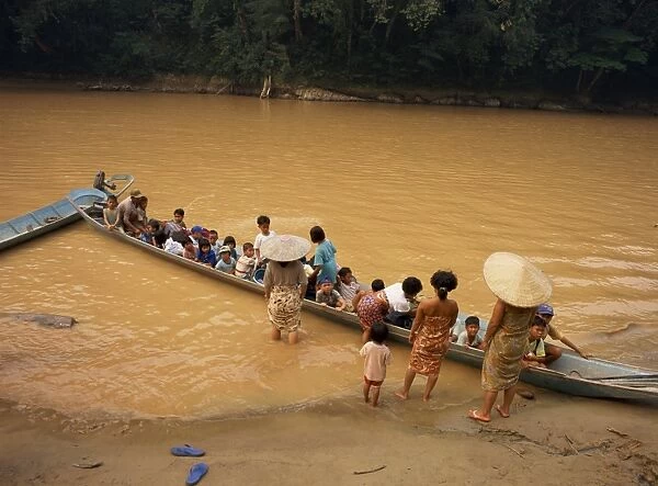 A longboat crowded with children leaving for week at school