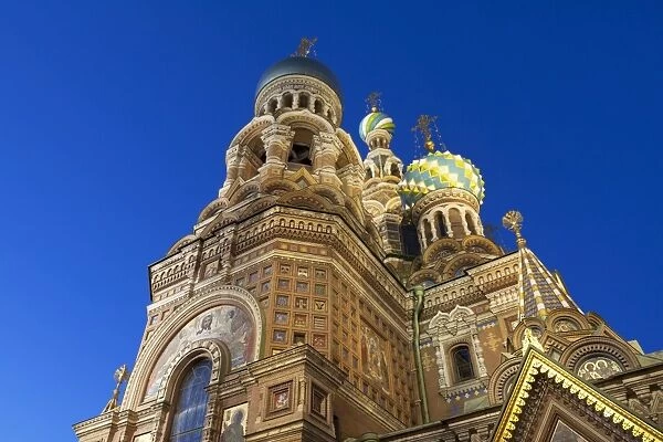 Looking up at the Church on Spilled Blood illuminated at dusk, UNESCO World Heritage Site, St. Petersburg, Russia, Europe