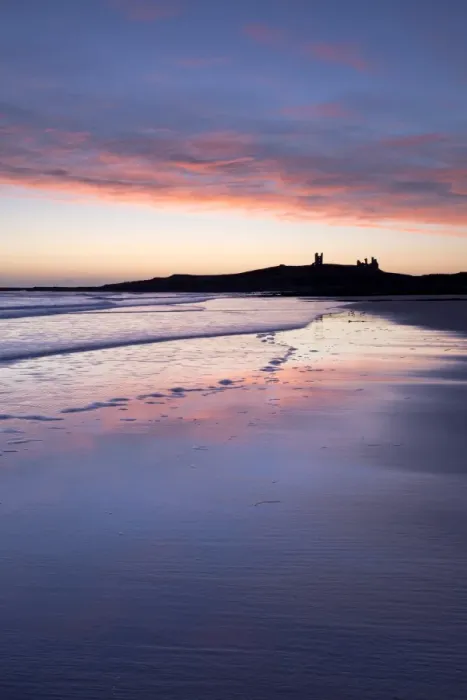 Framed Print : Looking across Embleton Bay at sunrise towards the silhouetted ruins of Dunstanburgh Castle in the distance and the vivid colours in the sky reflecting in the sea and wet sand, Embleton, near Alnwick, Northumberland, England, United Kingdom Framed Print : Looking across Embleton Bay at sunrise towards the silhouetted ruins of Dunstanburgh Castle in the distance and the vivid colours in the sky reflecting in the sea and wet sand, Embleton, near Alnwick, Northumberland, England, United Kingdom