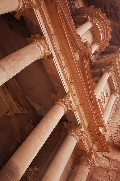 Looking up at the facade of the Treasury (Al Khazneh) carved into the red rock, Petra, UNESCO World Heritage Site, Jordan, Middle East
