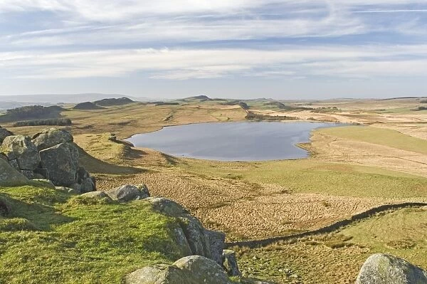 Looking west from above Sewingshields Crags over Broomlee Lough with the line of Hadrians Wall following the skyline, Hadrians Wall, UNESCO World Heritage Site, Northumbria, England, United