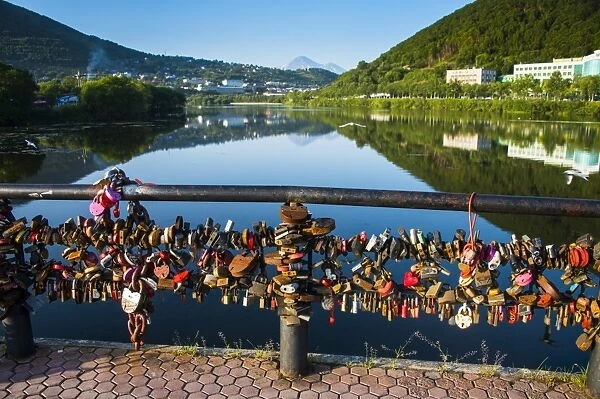 Lots of padlocks and chains on a handrail above an artifical lake in Petropavlovsk-Kamchatsky, Kamchatka, Russia, Eurasia