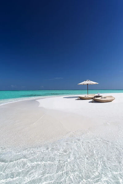 Two lounge chairs with sun umbrella on a tropical beach, The Maldives, Indian Ocean, Asia