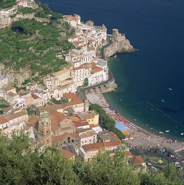 Low aerial view over the town and beach at Amalfi on the coast