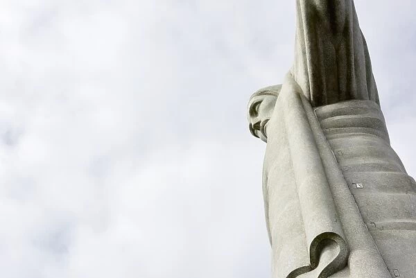 Low angle cropped shot of the iconic statue of Christ the Redeemer on a cloudy day