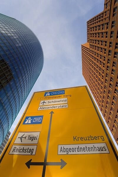Low angle view of traffic sign and skyscrapers