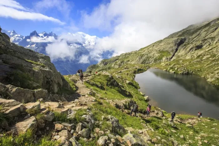 Framed Print : Low clouds and mist around Grandes Jorasses and Mont Blanc while hikers proceed on Lac De Cheserys Framed Print : Low clouds and mist around Grandes Jorasses and Mont Blanc while hikers proceed on Lac De Cheserys
