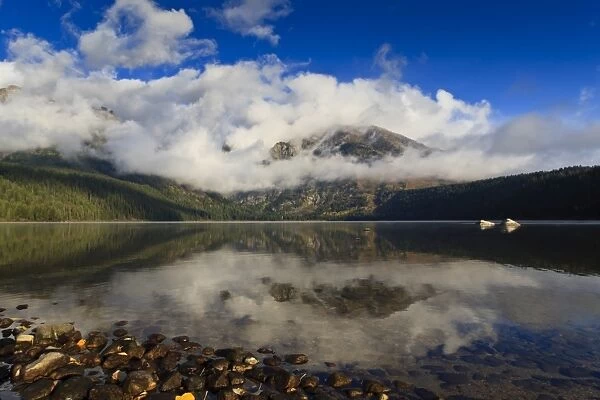 Low clouds and Teton Range reflected in Phelps Lake, Grand Teton National Park, Wyoming, United States of America, North America