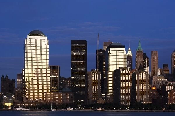 Lower Manhattan skyline at dusk across the Hudson River